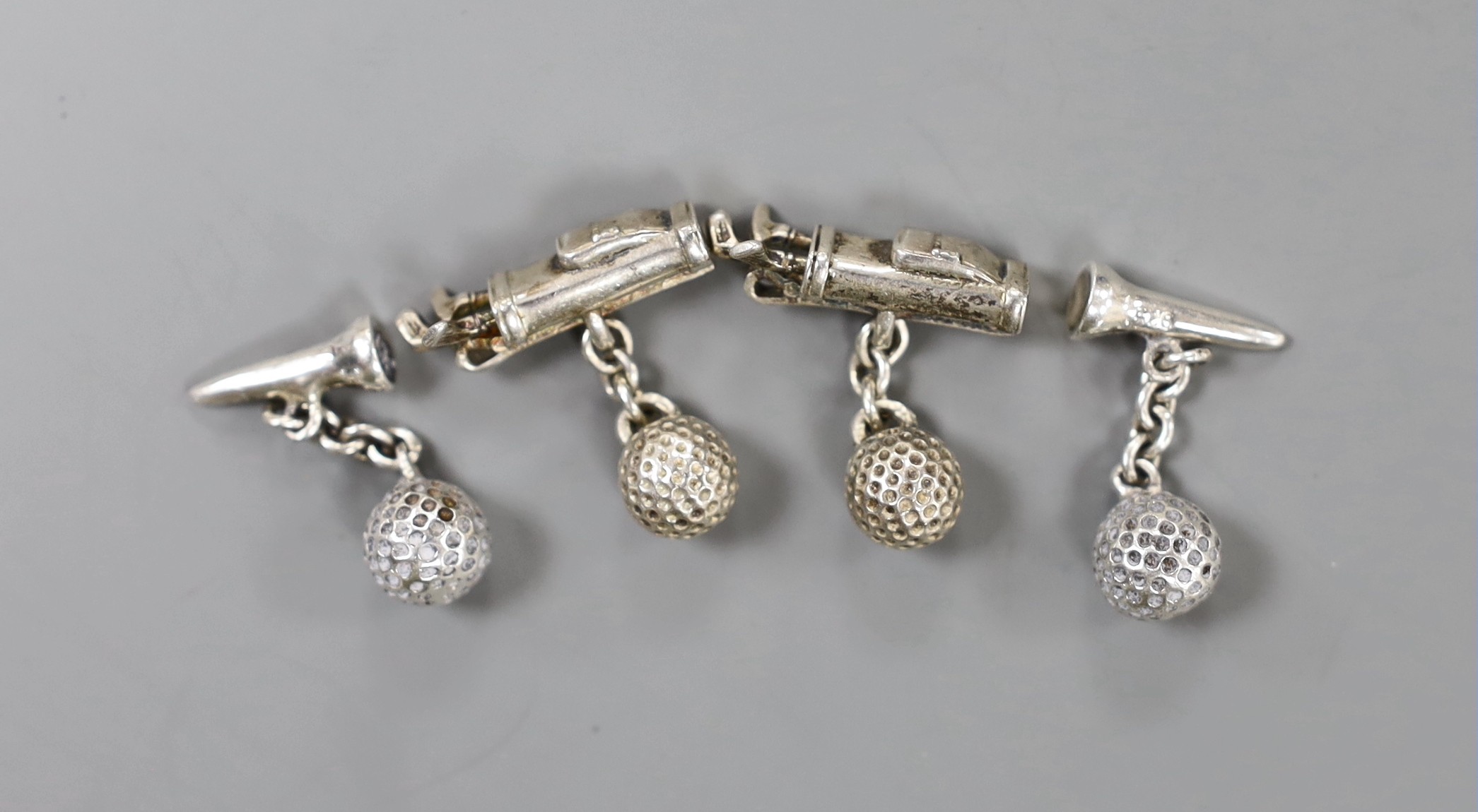 A modern novelty pair of silver 'golf clubs and ball' cufflinks and a similar 925 'golf ball and tee' pair.